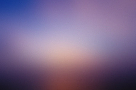 A moody blue and purple gradient with a soft light center and subtle grain texture.の写真素材