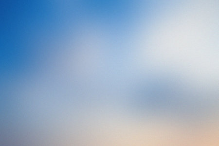 A soft blue and white gradient with subtle peach hues at the bottom. Clear details and vibrant co...の写真素材