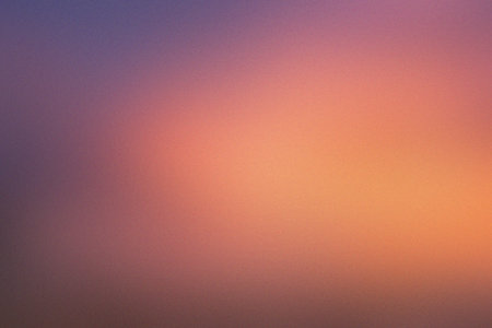 A warm gradient of pink and orange hues with a subtle grain texture, evoking a sunset.の写真素材