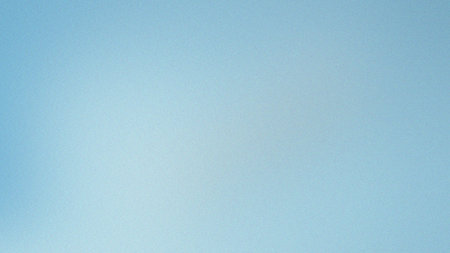 Light blue gradient background with a subtle grain texture, appearing airy and smooth.の写真素材