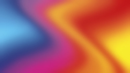 Abstract blurry gradient of blue, yellow, red, and pink on a frosted glass texture.の写真素材