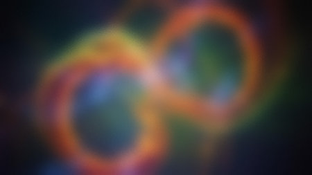 A blurred abstract shape resembling an infinity symbol in warm colors with a frosted glass texture.の写真素材