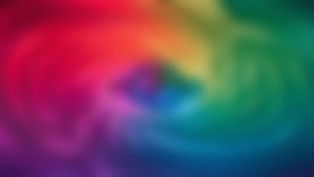 A blurred abstract background with a frosted glass texture and a rainbow swirl from red to blue.の写真素材