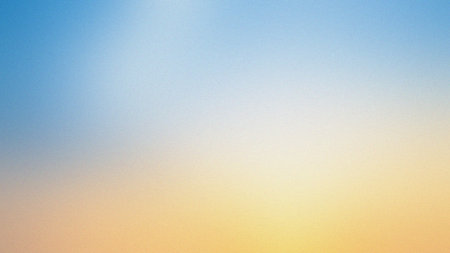 A bright blue to soft yellow and orange gradient creates a warm and cheerful background.の写真素材