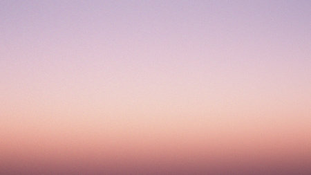 A gentle gradient blends soft pink and peach tones across a hazy sky. Clear details and vibrant c...の写真素材