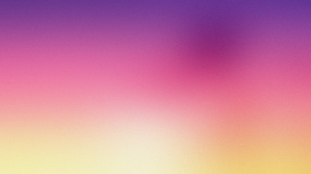 A soft gradient background transitions from purple and pink to yellow with a gentle blur.の写真素材