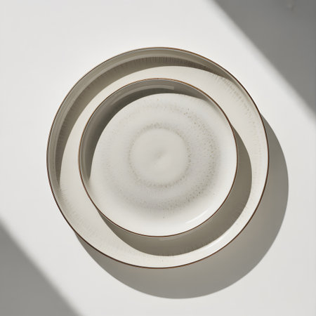 Two speckled ceramic plates stacked on a white surface with soft shadow. Clear details and vibran...の写真素材