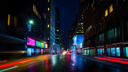 A city street at night with light trails from vehicles and illuminated neon signs. Clear details ...の写真素材