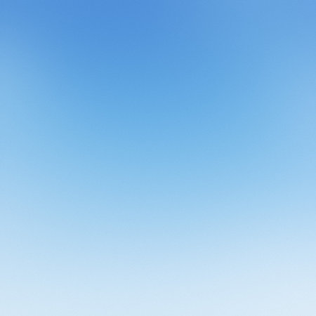 A clear blue sky gradient background with a subtle transition from dark to light blue.の写真素材