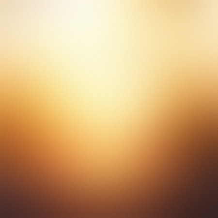 A warm golden yellow and brown gradient background with soft light and a smooth, blurred texture.の写真素材