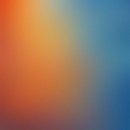 A smooth gradient blending from warm orange on the left to cool blue on the right with a soft focus.の写真素材