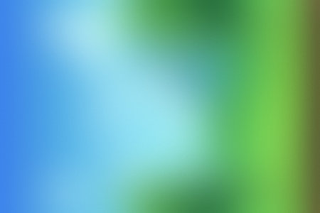 A soft, blurred gradient of blue and green creates a vibrant, diffused background texture.の写真素材