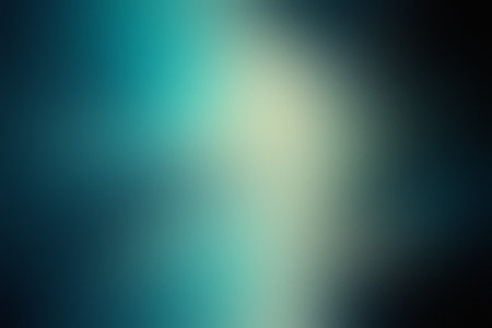 A deep blue and teal gradient with soft light and blurring creates a vibrant background.の写真素材