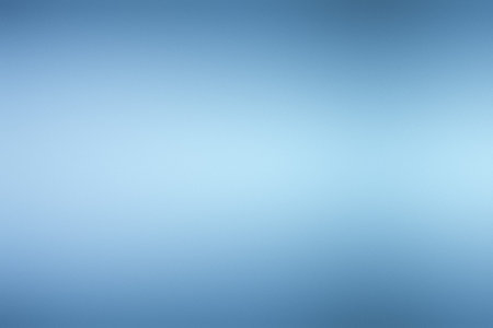 A smooth light blue gradient with a soft focus creates a serene and clean background.の写真素材