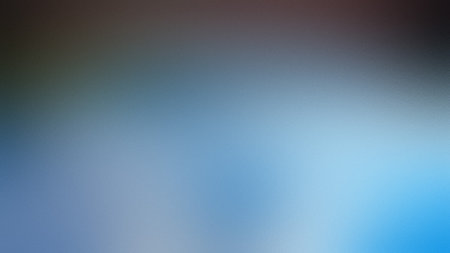 A blurred gradient background with soft transitions between blue, gray, and dark brown tones.の写真素材