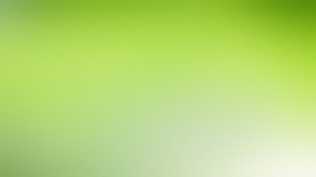 Bright lime green and white soft gradient background with a subtle diffused light effect.の写真素材