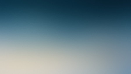 A smooth gradient transitioning from deep blue to light beige with a subtle texture, conveying...の写真素材