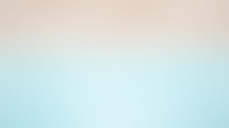 A soft gradient blends peach and light blue with a subtle texture and diffused light.の写真素材