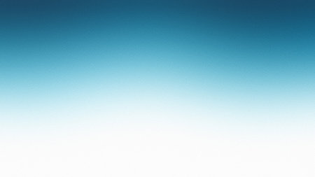 A smooth gradient transitions from deep blue to white with a subtle grainy texture.の写真素材