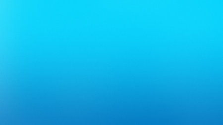 A smooth gradient transitions from bright cyan at the top to deep blue at the bottom.の写真素材