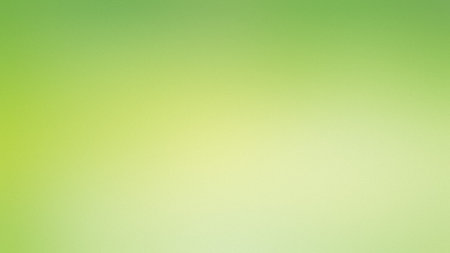 A soft gradient of green and yellow with a subtle texture creates a gentle backdrop.の写真素材