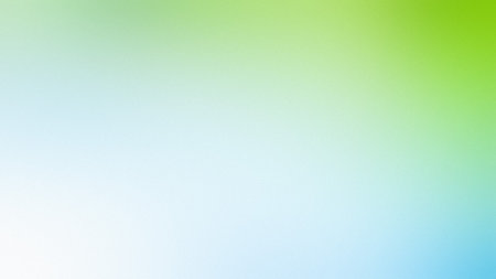 A smooth, blurred background with a gradient transitioning from white to light blue and green.の写真素材