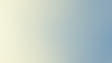 A soft gradient transitions from pale yellow on the left to light blue on the right.の写真素材