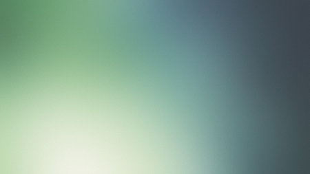 A soft gradient transitions from light green to deep blue with a subtle grainy texture.の写真素材