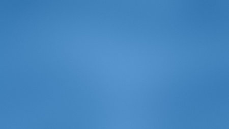 A smooth, solid gradient of deep blue fills the entire frame. Clear details and vibrant colors en...