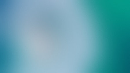 A soft blue and teal gradient with a subtle grain texture forms an abstract background.の写真素材