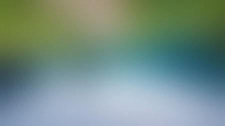 A soft gradient background blending green, blue, and white with a subtle textured appearance and...の写真素材