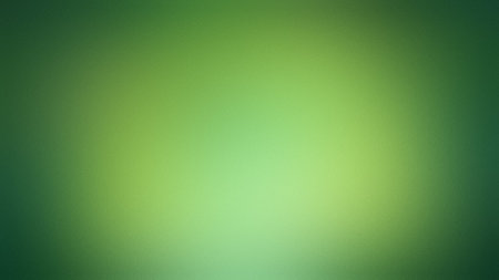 A vibrant green gradient background with a soft, diffused light effect and subtle texture.の写真素材