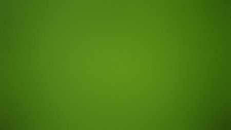 A solid, vibrant green gradient background with a subtle, smooth texture and even lighting.の写真素材