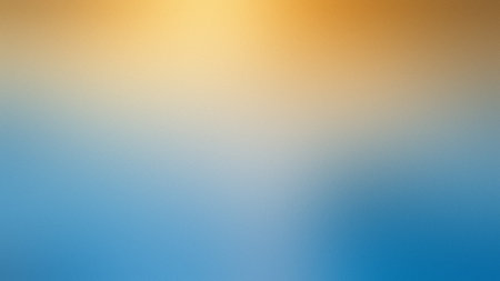 A warm yellow and blue gradient with a subtle grain texture creates an abstract backdrop.の写真素材