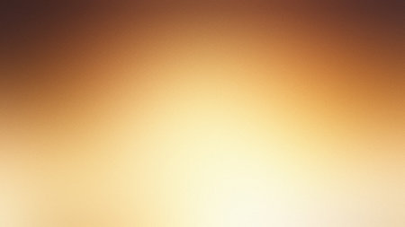 A warm golden yellow gradient background with a subtle texture and soft, bright lighting.の写真素材