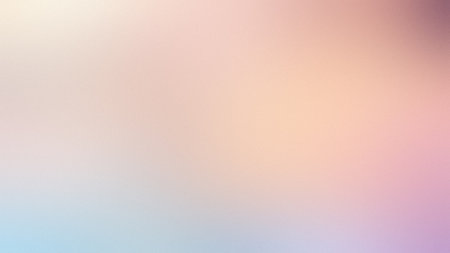 A gentle, blurred gradient background featuring soft pastel hues of pink, peach, and light blue.の写真素材