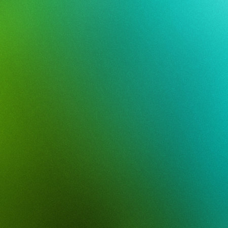 A smooth gradient transitions from deep green to bright teal with a fine grain texture.の写真素材