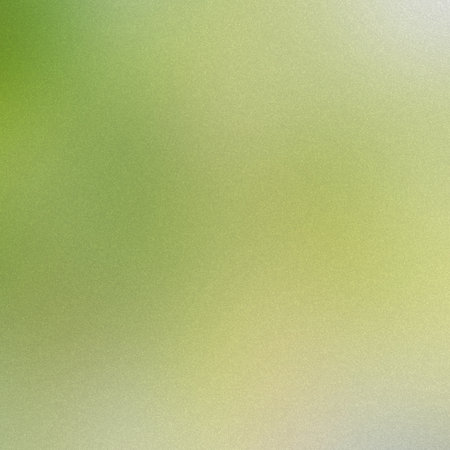 A soft green and yellow gradient with a fine grain texture, creating a gentle backdrop.の写真素材
