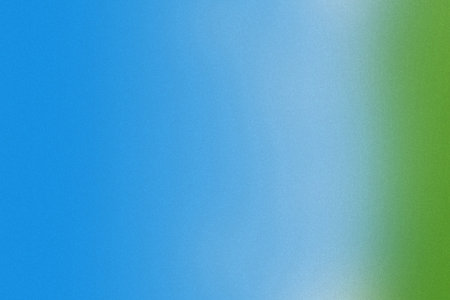 Bright blue and green gradient background with a subtle grainy texture and soft transitions.の写真素材