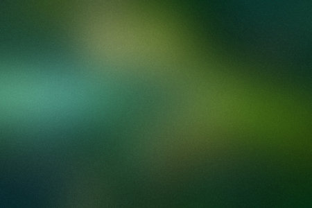 A blurred gradient of dark green and yellowish green with a grainy texture. Clear details and vib...の写真素材