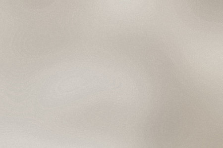 A subtle beige textured background with fine grain and a soft gradient. Clear details and vibrant...の写真素材