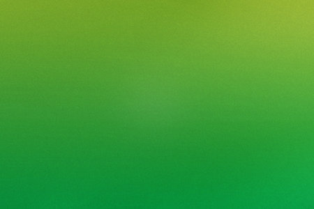 A vibrant green gradient background transitions from light to dark with a subtle grainy texture.の写真素材