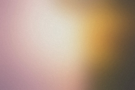 A soft gradient transitioning from pink to gold with a subtle grain texture, creating a warm glow.の写真素材
