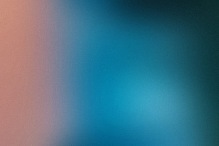 A gradient of soft pink to vibrant blue with a fine grain texture, creating a diffused backdrop.の写真素材