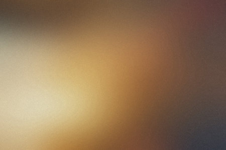 A blurred gradient of warm golden brown and dark brown with a subtle grainy texture.の写真素材