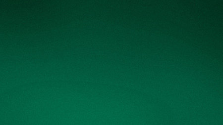 A deep emerald green gradient background with a subtle grain texture and a dark vignette.の写真素材