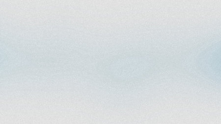 A pale blue and white gradient abstract background with a fine grain texture. Clear details and v...の写真素材