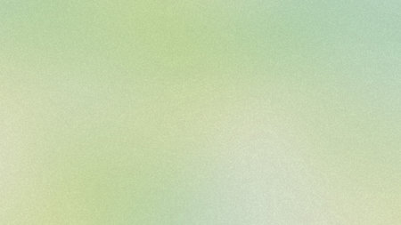 A soft gradient background with subtle green and yellow hues and a fine grain texture.の写真素材