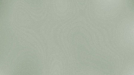 A soft green speckled gradient texture with a subtle, smooth, and clean appearance.の写真素材