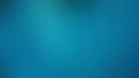 A vibrant blue gradient background with a fine speckled grain texture. Clear details and vibrant ...の写真素材